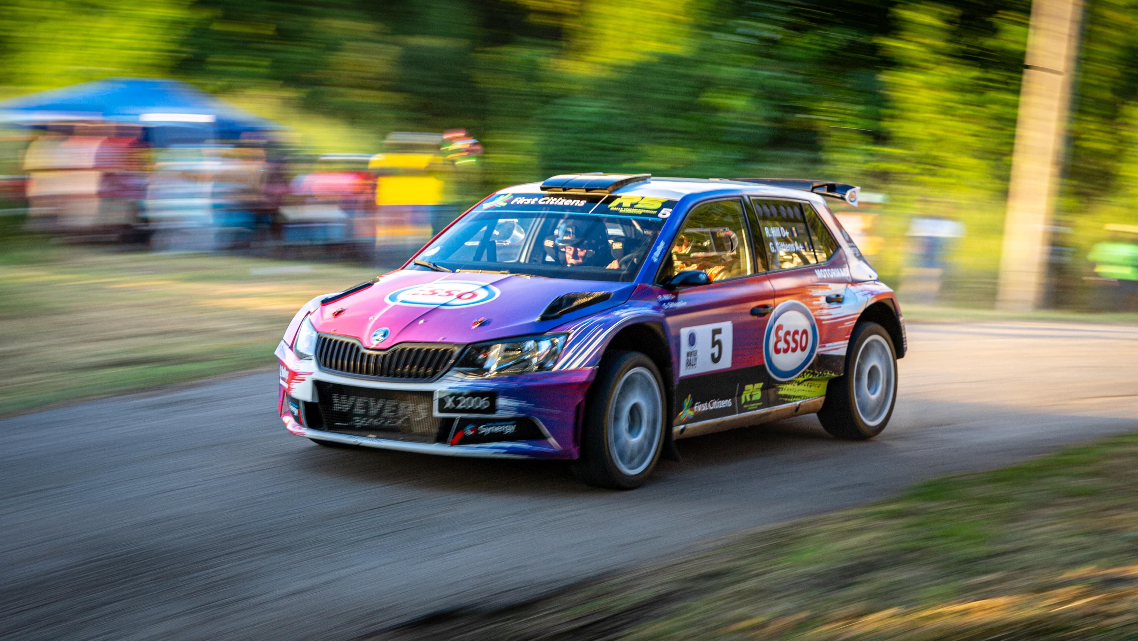 GT race cars battling on track at golden hour